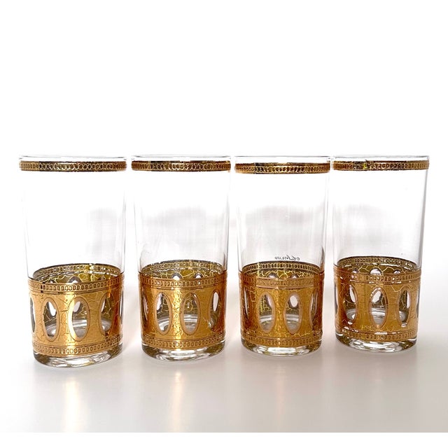 Four 1970s Culver highballs in Antigua Neoclassical pattern. Made in molded clear glass with 22K bands with crackle...