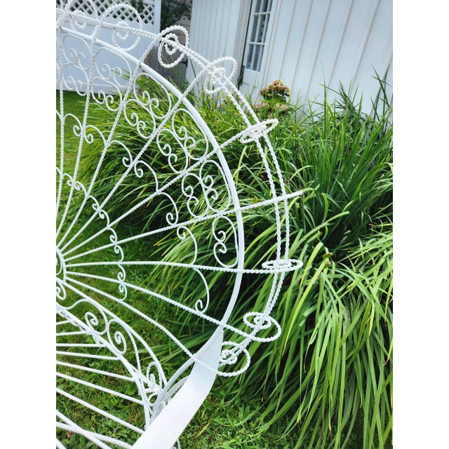 This vintage Boho wrought iron peacock settee, inspired by Salterini, combine intricate ironwork with a whimsical design,...