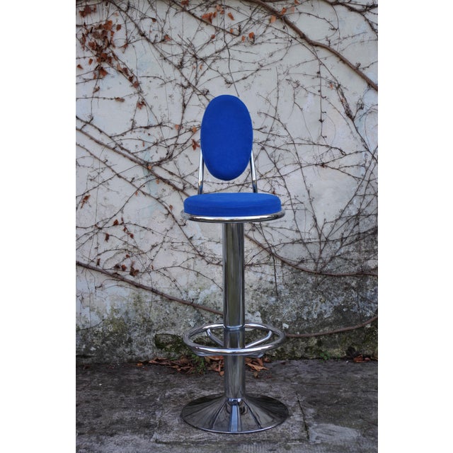 Chrome rotating stool in 1990s-2000s blue microfiber.