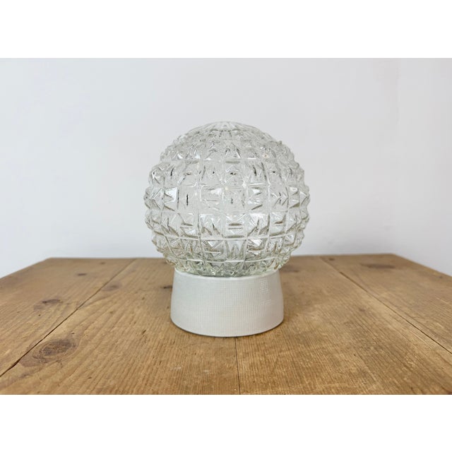 Vintage industrial ceiling or wall light made in former Czechoslovakia during the 1970s. It features a white porcelain...