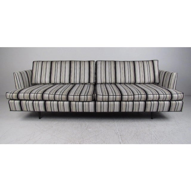 This spacious Dunbar sofa features deep upholstered seats with unique vintage striped fabric. The cutaway armrests and...