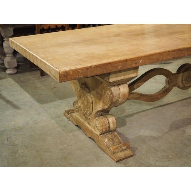 Dating to the early 1900s, this French dining table features a three-inch thick top supported by two wide pedestal legs...