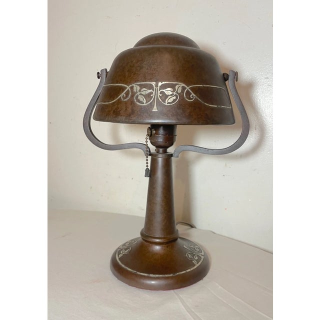Crafted during the pinnacle of the Arts & Crafts Movement, this Heintz desk lamp marries functionality with exquisite...