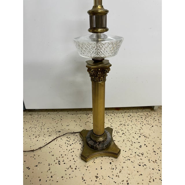 Antique brass classical reeded Corinthian column on a marble base with a cut crystal glass spirit or oil reservoir. Was an...