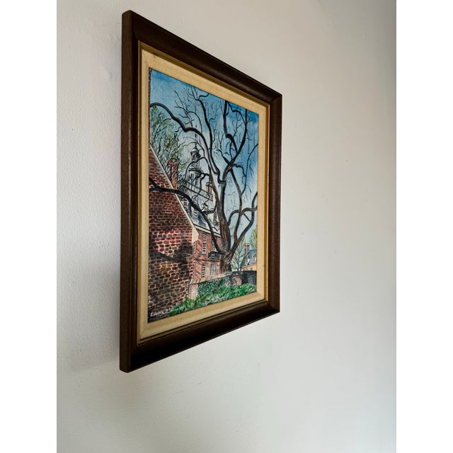 This vintage oil painting captures the quiet beauty of a historic brick building framed by the intricate, leafless...