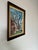 This vintage oil painting captures the quiet beauty of a historic brick building framed by the intricate, leafless...