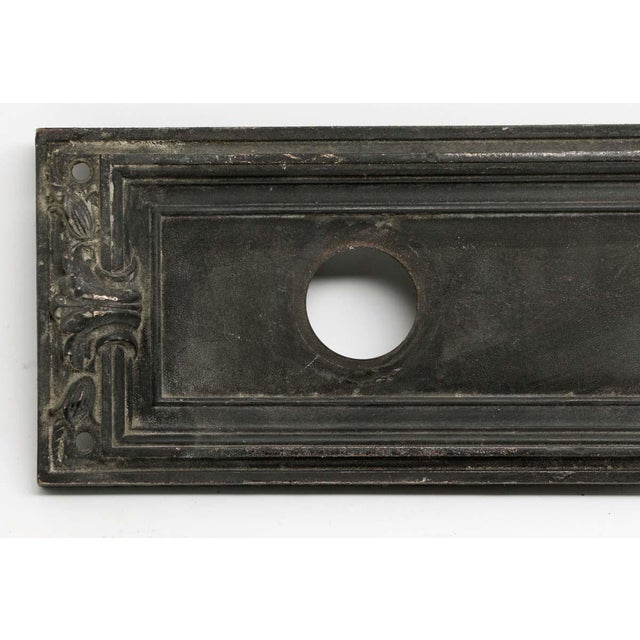 Art Deco style bronze push plate with a cylinder lock insert made by Russwin. Inscribed Ceres 521 626. One available. The...