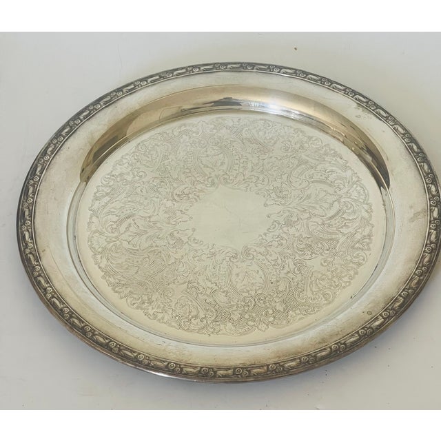 Antique round ornate border incised silverplate serving platter, 15” diameter.