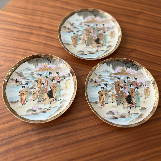 A beautiful set of 3 delicate, hand-painted, porcelain plates. Such a peaceful scene...a river crossing, painted in the...