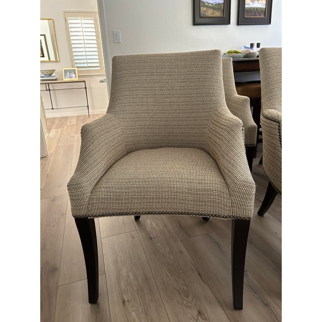 A set of 6 Dining Chairs by Bernhardt Furniture. Chairs are accented with pewter nailheads and legs are finished in a...