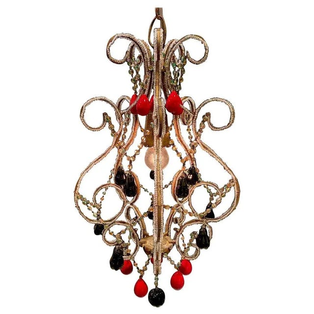 Italian Hollywood Regency pendant light with Venetian fruits and beads, circa 1950. The iron frame has a painted gold...