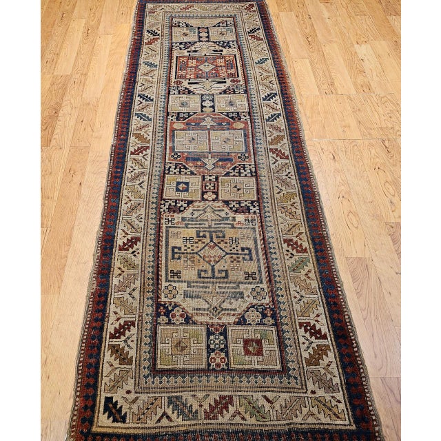 A striking example of 19th-century Caucasian village artistry, this antique Kazak runner features the bold geometric...