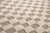 A timeless grid, softened by the hand. A classic checkerboard pattern unfolds across this piece, alternating squares of...