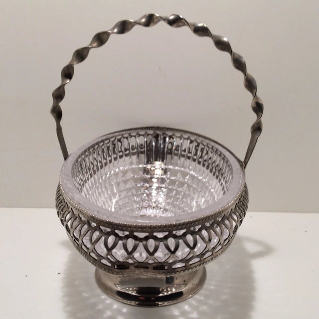 This lovely little nickle-plated Basket has its original crystal cut inset bowl and a twisted metal handle. The bottom has...