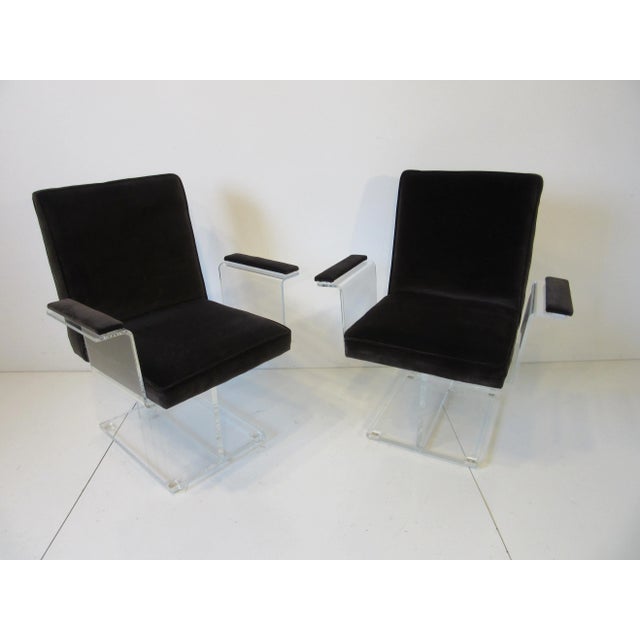 A pair of Kagan Lucite pedestal armchairs upholstered in a dark chocolate velvet fabric having a great sculptural look...
