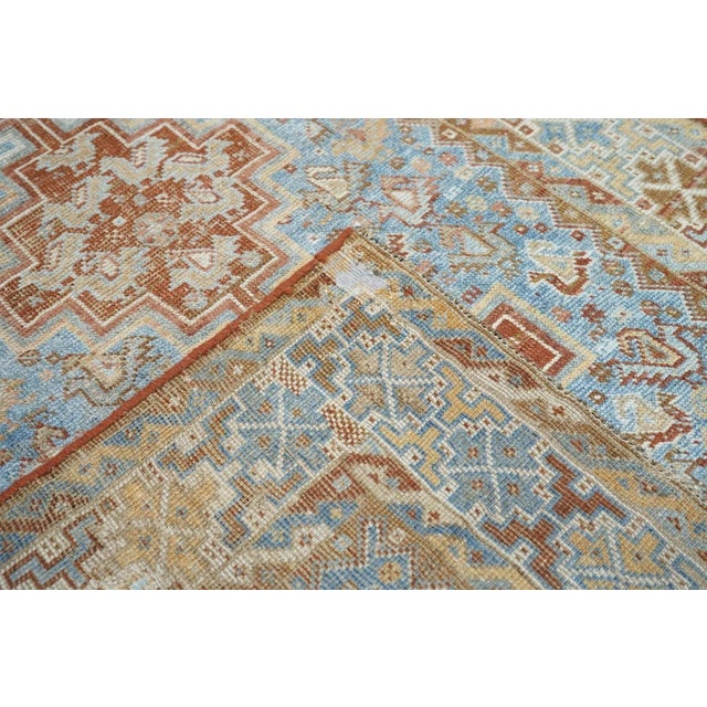 This Shiraz-area tribal scatter presents a red, chicken-filled, tripartite pole medallion, set on a light blue field with...