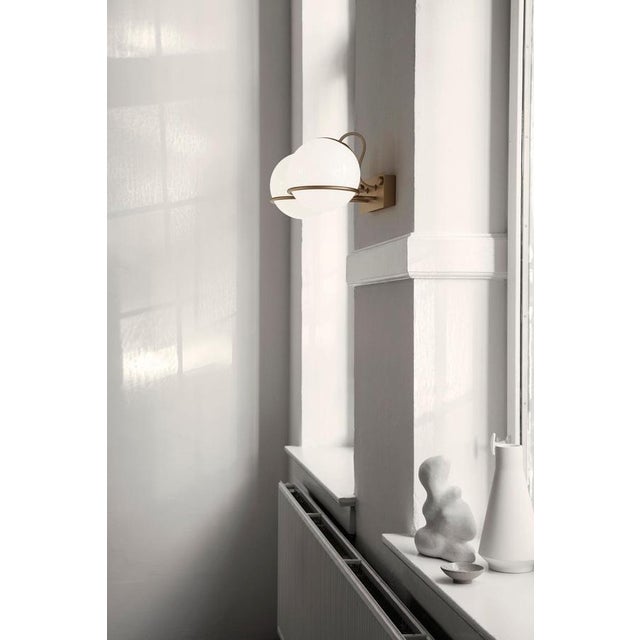 Model 238/1 design by gino sarfatti the single blown opaline glass sphere is gently held by a black or champagne painted...