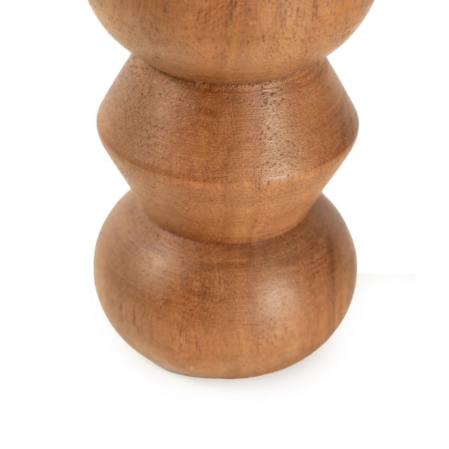 Handcrafted from richly grained wood, this sculptural candle holder features a playful stacked silhouette with alternating...