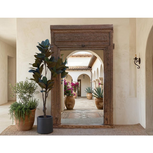 The Heritage Portal" is a monumental work of architectural salvage, transformed into a breathtaking floor mirror. Standing...