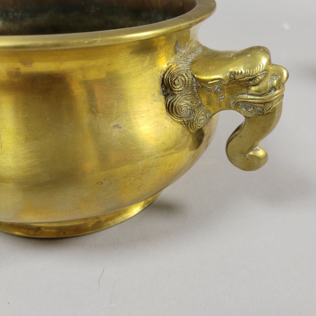 A well-cast antique Chinese bronze censer of compressed globular form, raised on a short circular foot and fitted with...