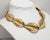 Late 1970s goldtone textured frosted graduating leaves slightly overlapping each other in a line collar necklace with fold...