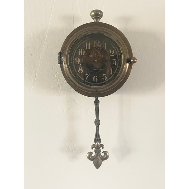 This timepiece is a Hotel Pasquier Wall Clock, a decorative battery-operated clock often associated with the Monticello...