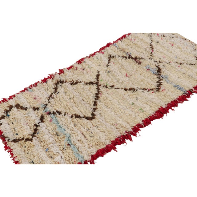 Hand-knotted in wool and circa 1950-1960, this vintage 3x5 Moroccan rug is believed to hail from the Azilal tribe. On the...