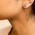 Early 21st Century .925 Sterling Silver Round-Cut Diamond Accent Swirl Square Knot Stud Earrings (H-I Color, I2-I3 Clarity) For Sale - Image 5 of 6