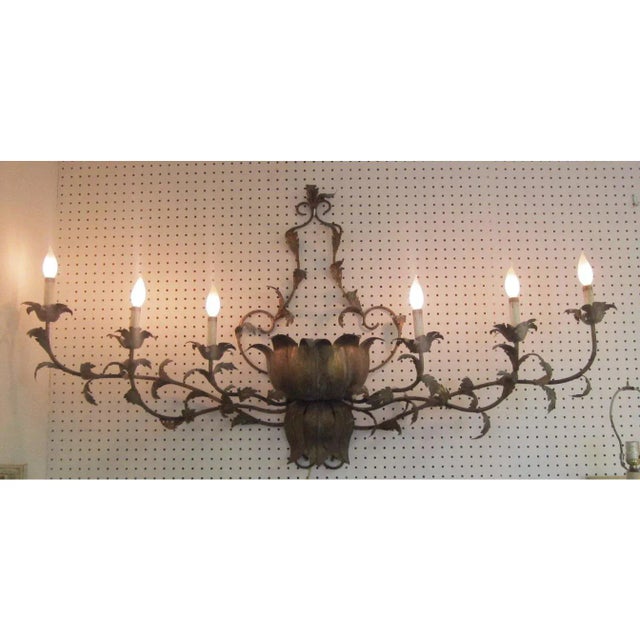 Large metal six light wall sconce from the mid 20th century. The Hollywood Regency Italian style piece has a gold finish...