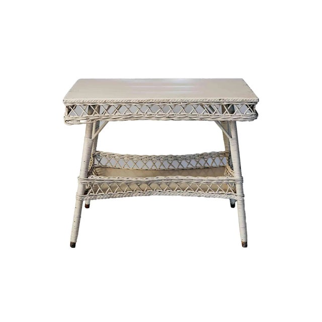 Antique two tiered wood and stick wicker table, Has a creamy, off white, high gloss vintage finish. Some surface wear on...