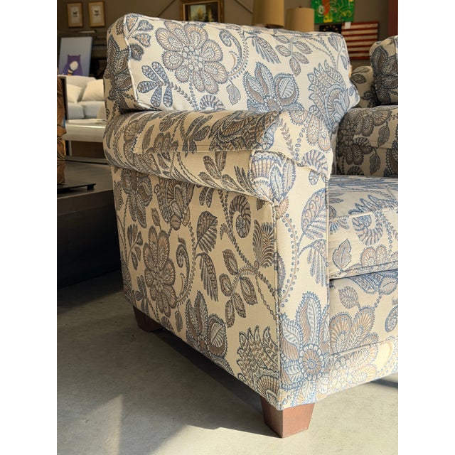 A charming pair of American-made Smith Brothers armchairs, combining traditional craftsmanship with the decorative appeal...