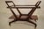 This Italian trolley was produced during the 1950s. The frame is made from a dark walnut and supports a glass top for...