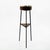 Sculptural mid-20th-century standing ashtray combining brass, wood and black painted metal. The unusually slender three-...