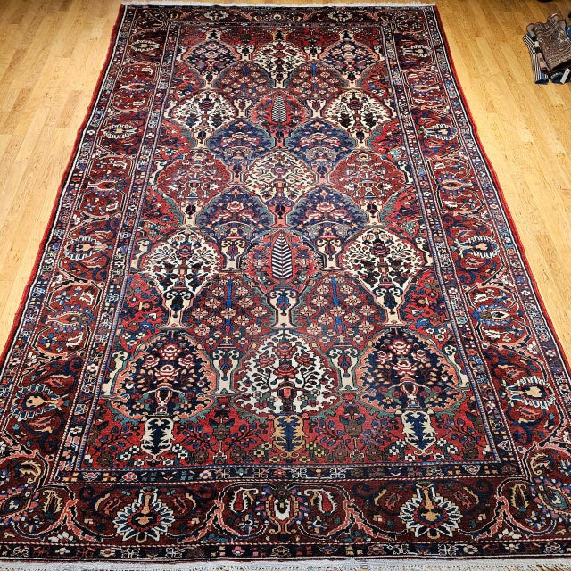 "This exquisite vintage oversized Persian Bakhtiari rug showcases a stunning allover floral vase panel design, handwoven...