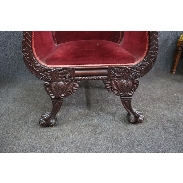 American Empire chair , solid mahogany frame , carved serpent arms , large paw feet , red velvet upholstery