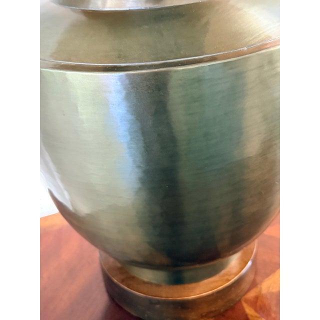 A beautifully crafted American Mid-Century Modern table lamp featuring a hand-spun solid brass, hand-hammered body with a...