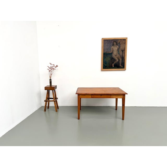 Solid pine farmhouse table, french work from the 1950s. the tabletop is made of assembled pine planks, framed by two end...