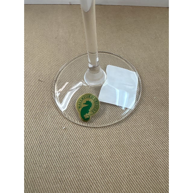 The Waterford Lismore Diamond Champagne Flute is a tall, elegant glass made from fine crystal, featuring deep diamond and...