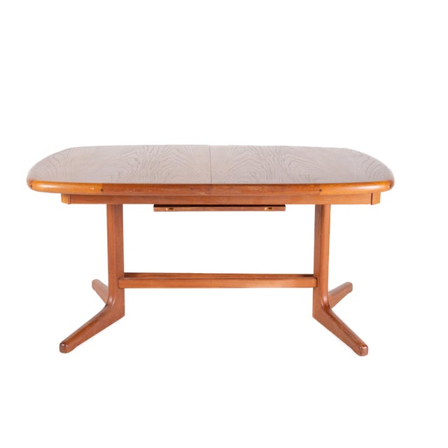 Dyrlund Style Mid Century Teak Hidden Leaf Dining Table The table measures: 58 wide x 38 deep x 28 high, with a chair...