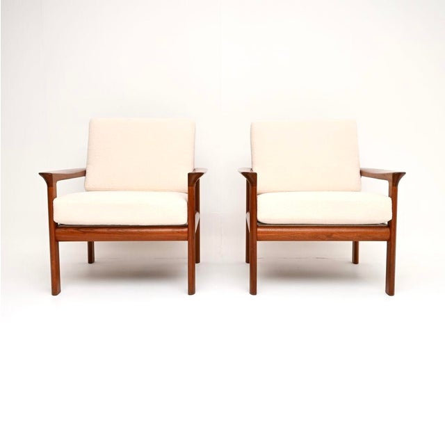 A stylish and extremely comfortable pair of Danish vintage teak armchairs by Sven Ellekaer. This model is called the...