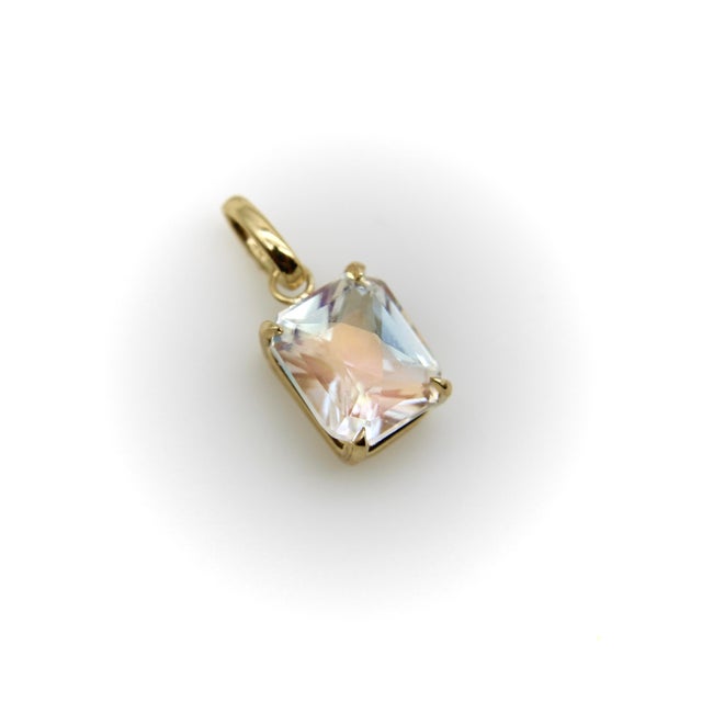 This 14k gold pendant features an incredible rectangular fancy cut Madagascar rainbow moonstone. Discovered in 2023 in the...