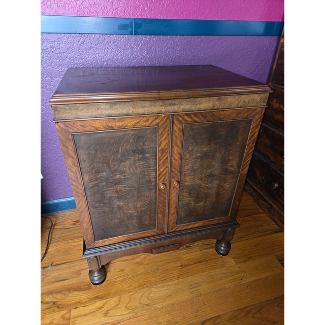 This is a beautiful victrola cabinet that has been converted for storage, maybe a record player and records, or even a bar...