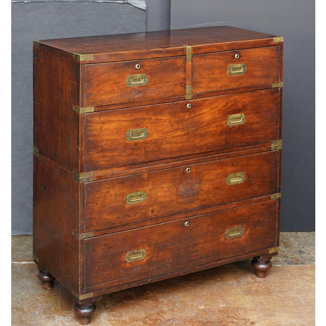 A handsome British military officer’s Campaign Ware chest of drawers or dresser, from the 19th century, featuring a...