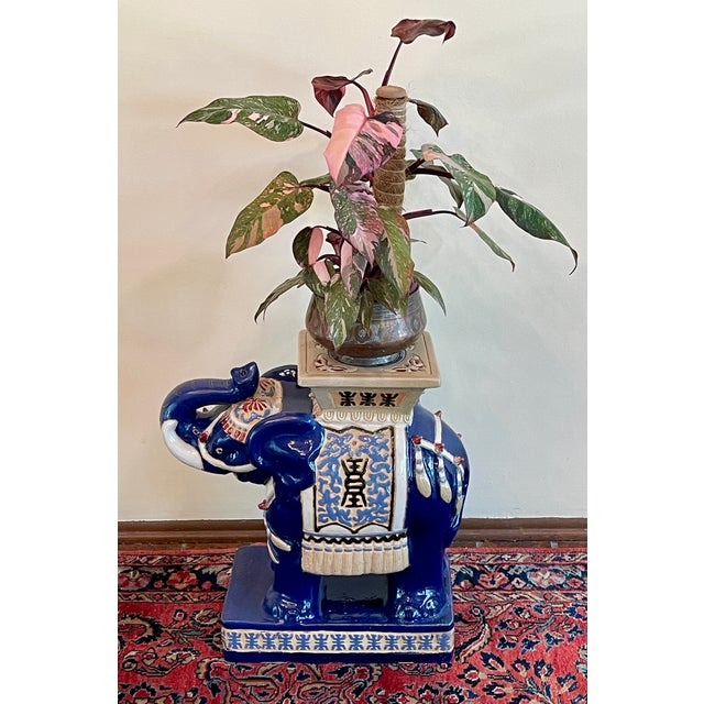 Colorful ceramic elephant garden stool with navy, cream, garnet and gold glazing. Suitable for use indoors or out as a...