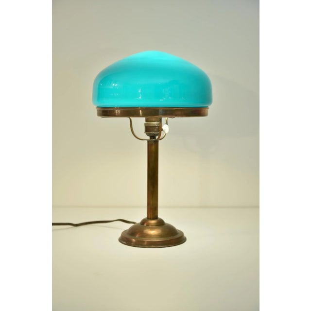 Swedish grace table lamp, early 1920´s made of copper with simple but yet beautiful details and a bluegreen hand blown...
