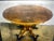 Antique oval pedestal/center table featuring a beautifully crafted central column and an ornately shaped base with four...