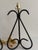 This listing is for a pair of vintage wrought iron table lamps with tall open scrollwork frames and a black finish. The...