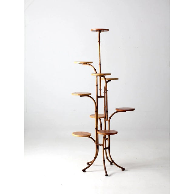 This captivating mid-20th-century plant stand features a metal frame designed to resemble bamboo, supporting nine wooden...