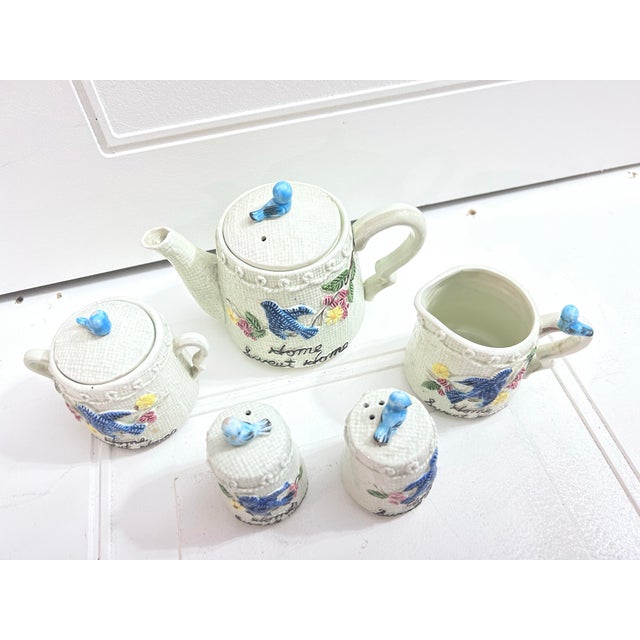 This is a vintage Enesco "Bluebird" ceramic tea set featuring a "Home Sweet Home" theme, likely from the 1950s.