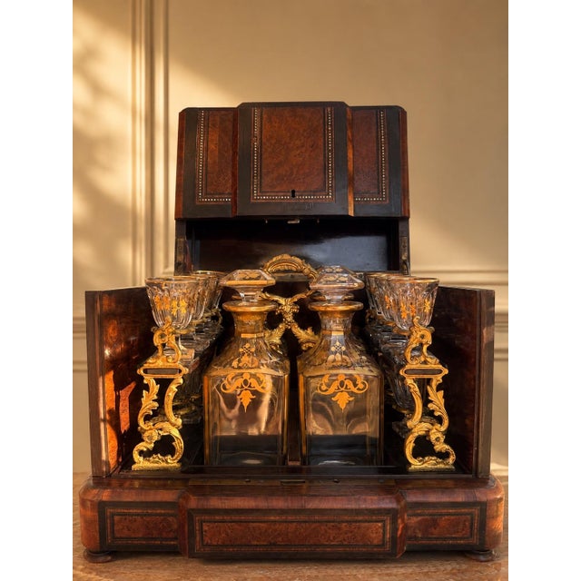 A striking 19th century French cave à liqueur, beautifully crafted in richly figured wood with mother-of-pearl inlay,...